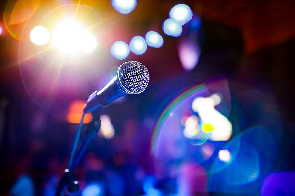 Microphone on stage against a background of auditorium. Karaoke Olde Town Conyers - Microphone
